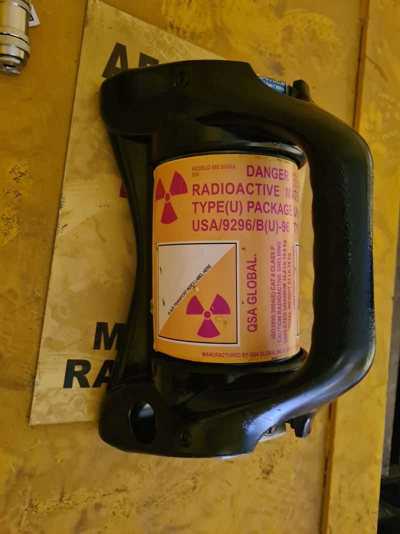 Irradiador gama com rótulo de embalagem tipo U para transporte de material radioativo, sobre base amarela